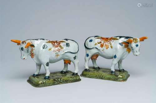 A pair of Dutch Delft partly cold painted polychrome cows, 1...