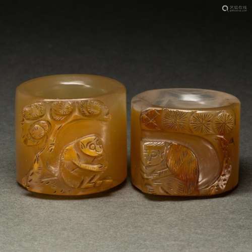 Pair of Chinese agate 'monkey and pine' archer's rings