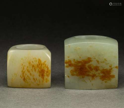 (lot of 2) Chinese celadon and russet jade archer's rings