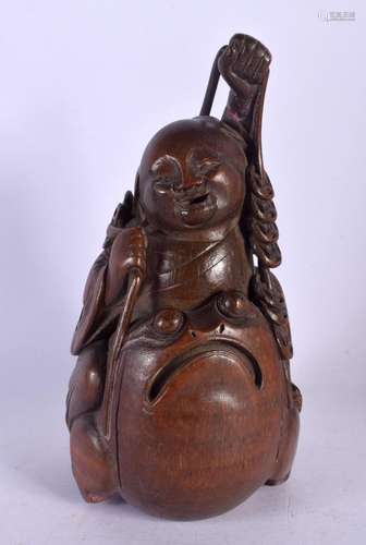 A CHINESE QING DYNASTY CARVED BAMBOO FIGURE OF A BUDDHA mode...