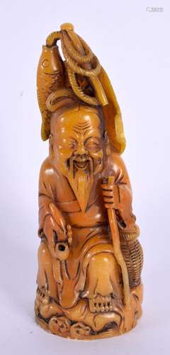 AN EARLY 20TH CENTURY CHINESE CARVED ORANGE STONE FIGURE OF ...