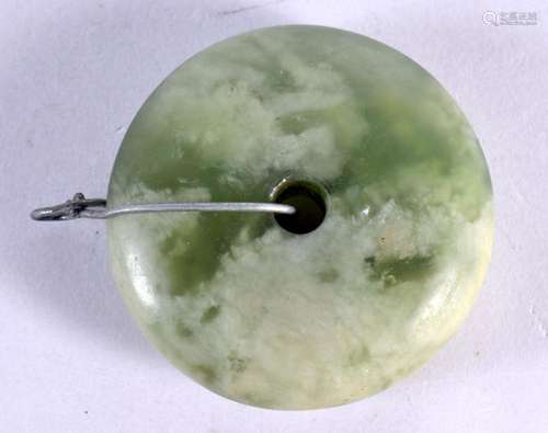 A CHINESE QING DYNASTY CARVED GREEN JADE BI DISC TOGGLE. 4.5...