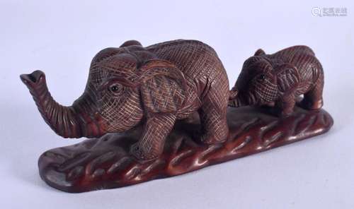 A JAPANESE CARVED WOOD ELEPHANT OKIMONO. 12 cm x 4 cm.