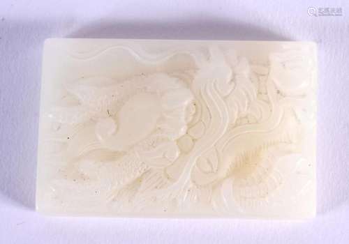 A CHINESE CARVED JADE TABLET 20th Century. 6 cm x 3.75 cm.