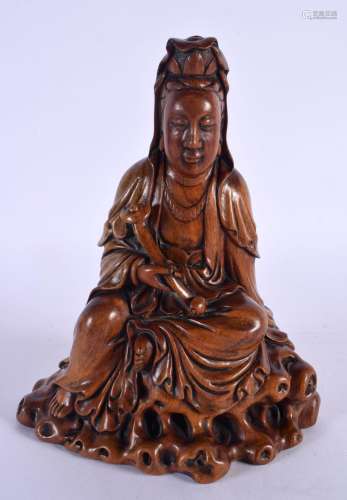 AN EARLY 20TH CENTURY CHINESE CARVED WOOD FIGURE OF AN IMMOR...