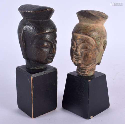 TWO 19TH CENTURY CHINESE BRONZE BUDDHA HEADS. 12 cm high.