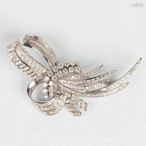 A brooch made of white gold and decorated with approximately...