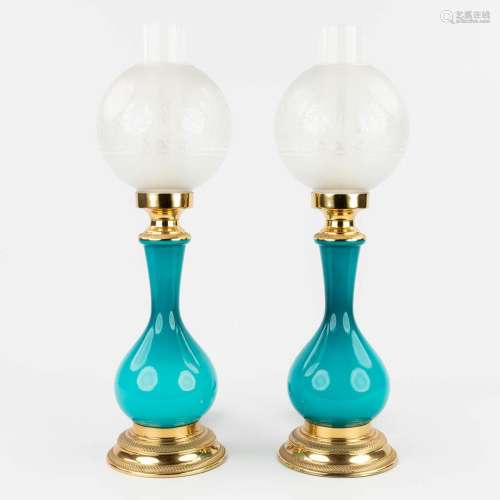 A pair of table lamps, opaline blue glass mounted with bronz...