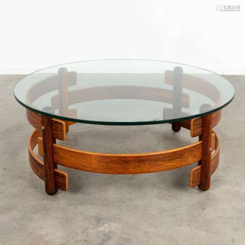 A mid-century round coffee table, rosewood with a glass top....