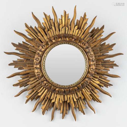 A small and vintage sunburst mirror, sculptured wood and a c...