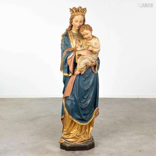 An antique wood-sculptured Madonna with child, original poly...