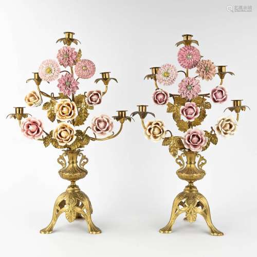 A pair of church candlesticks, brass with porcelain flowers....