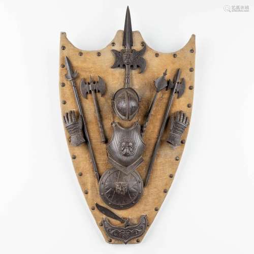 A decorative wall-mounted frame with pieces of armour. 20th ...
