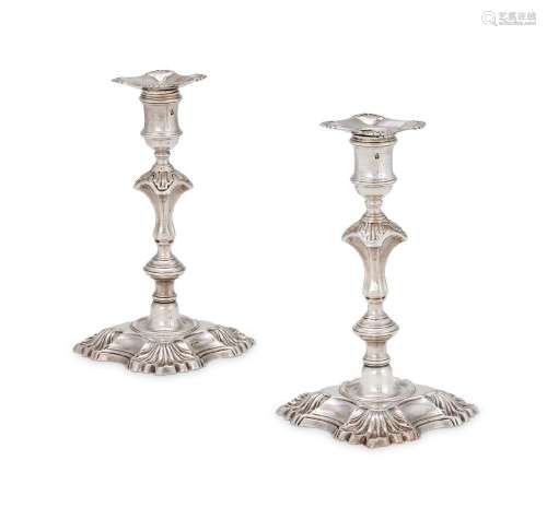 A PAIR OF GEORGE II CAST SILVER CANDLESTICKS