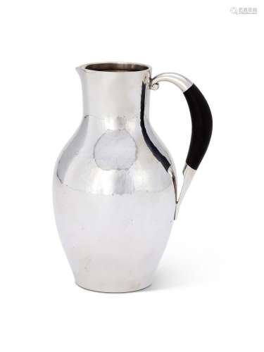 Y GEORG JENSEN, A DANISH SILVER COLOURED WATER JUG OR PITCHE...