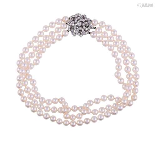 A THREE STRAND CULTURED PEARL NECKLACE WITH FRENCH DIAMOND C...