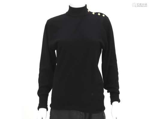 A black wool Chanel turtleneck sweater. With buttons on the ...