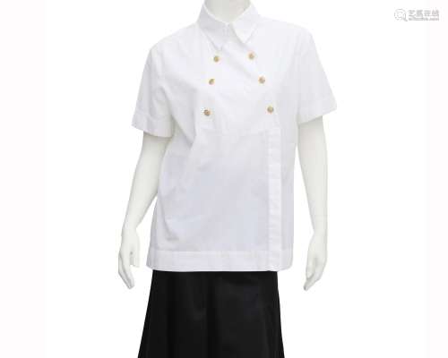 A white Chanel shirt with gold tone buttons. The shirt has s...