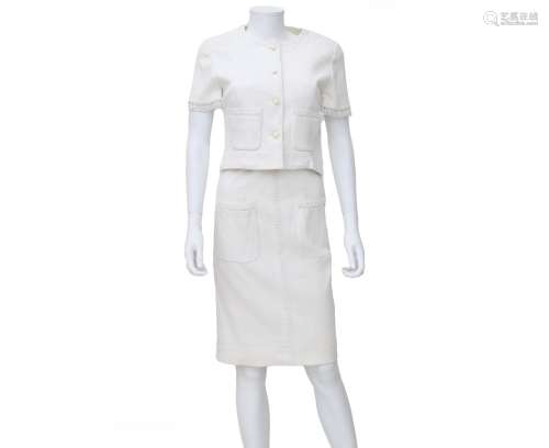 A white Chanel Boutique ensemble of a dress and jacket. The ...