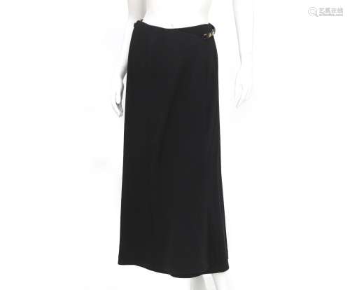 A black skirt from Hermès with belt detail. The long wool wr...