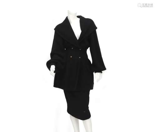 A black double breasted coat by Chanel. With open collar, lo...