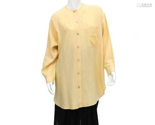 A Chanel Boutique yellow blouse, the blouse has an external ...