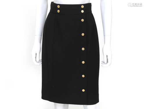 A black Chanel skirt with gold colored buttons. The buttons ...