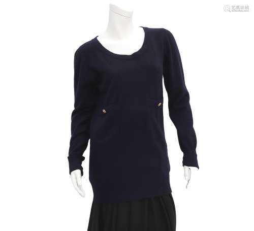 A dark blue Chanel sweater with gold colored buttons, the bu...