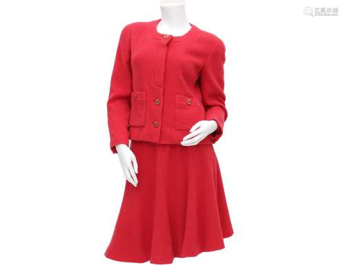 A Chanel Boutique ensemble of a fusia pink blazer and skirt....