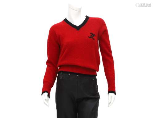 A red and black Chanel knitted sweater. The CC logo is incor...
