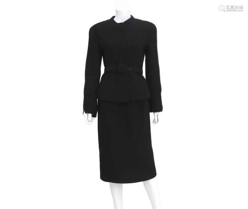 A black Chanel ensemble of a blazer, skirt and belt. The bla...