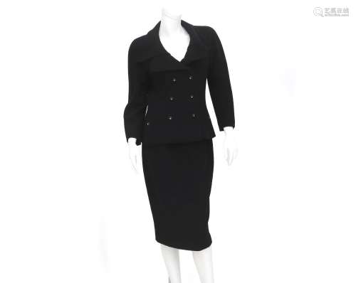 A black Chanel Boutique ensemble of a blazer and a skirt. Th...