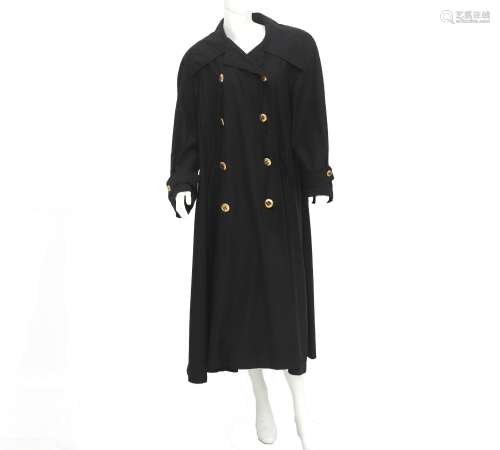 A black Chanel Boutique trench coat. The coat has two rows o...