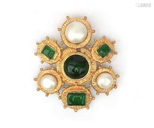 A Chanel brooch in Byzantine style. A gold tone brooch featu...