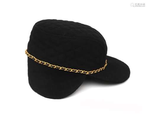 A black wool Chanel cap. Quilted overall, and feauturing gil...