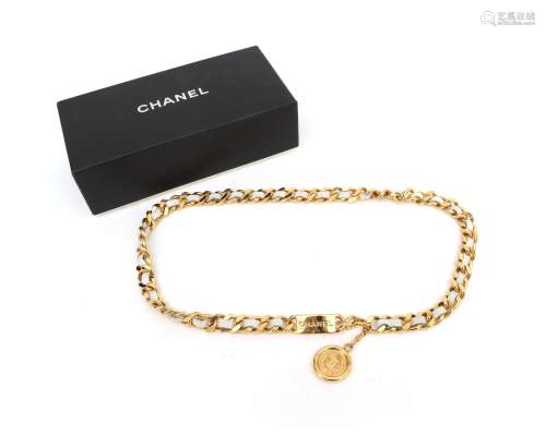 A gold tone and white leather Chanel chain belt. A gilded an...
