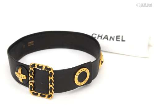 A black leather Chanel belt, ca. 1993. With large gold tone ...
