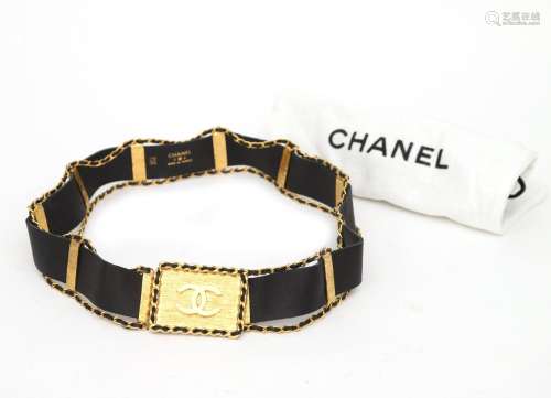 A black leather Chanel interlaced belt with CC logo buckle. ...