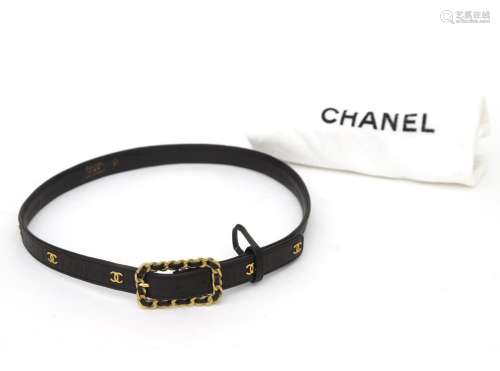 A black leather Chanel belt with CC logo studs. Chanel chain...
