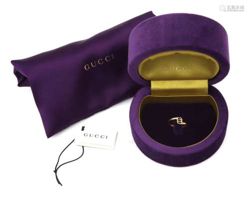 An 18 karat gold Gucci monogram ring. Designed as intertwine...