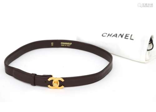 A brown leather Chanel Matrasse turn Lock belt. A slim belt ...