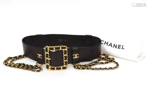 A black leather Chanel belt with gilded details. A wide lam`...