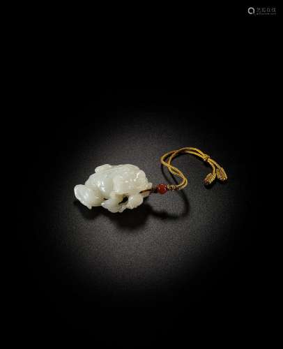 A FINELY CARVED WHITE JADE 'TOAD AND POMEGRANATE' GROUP Qian...