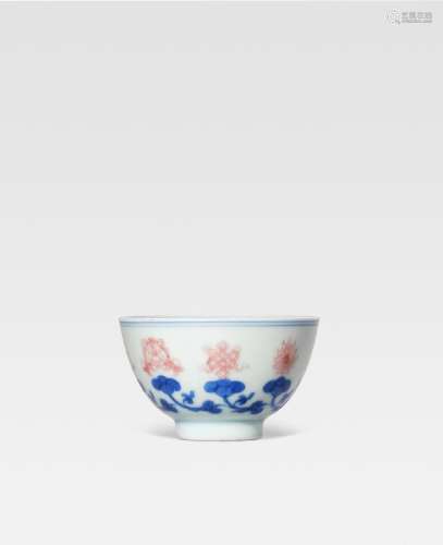AN UNDERGLAZE-BLUE AND COPPER-RED 'EIGHT EMBLEMS' CUP Yongzh...
