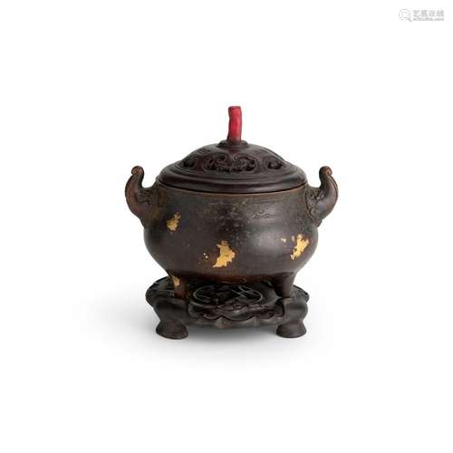 A GILT-SPLASHED BRONZE TWO-HANDLED TRIPOD CENSER Qianlong ma...