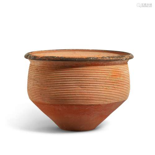 A large deep pottery bowl with horizontal grooves, Dawenkou ...