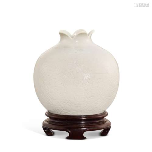 A soft-paste white porcelain carved 'pomegranate' wa...