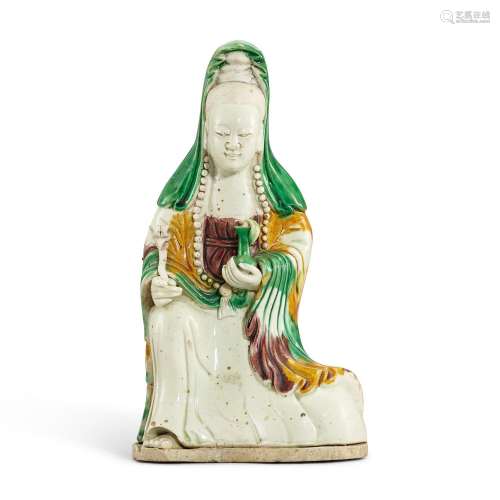 A biscuit-enamelled sancai figure of Guanyin, Qing dynasty, ...