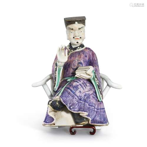 A famille-rose figure of a Daoist priest seated on a white-g...