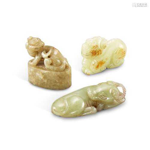 Three celadon and russet jade 'animal' carvings, Qin...